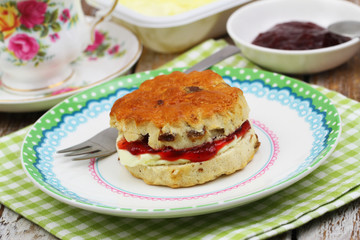 Traditional English scone with strawberry jam and fresh clotted cream
