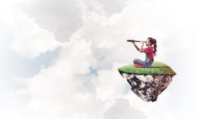 Concept of careless happy childhood with girl looking in spyglas