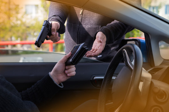 The criminal committed an armed robbery of the driver of the car.