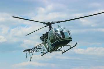 Fototapeta na wymiar helicopter fly near the forest