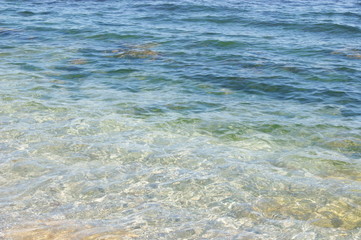 Stones on the beach, waves, beach, blue water. Summer.