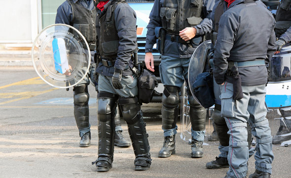 Group of anti-riot police officers with bullets and protective shields during security checks
