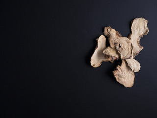 Slices of dried galangal or galanga root from Thailand isolated on black background