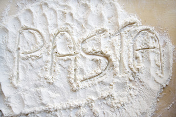 the word pasta written with the flour