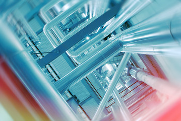 Industrial Factory. Various mechanisms and metal pipes. Toned image. Motion blur effect.