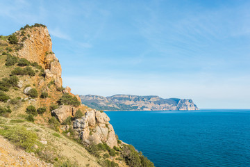 Fototapeta na wymiar Rocky cliff above the beautiful clear blue Sea, Crimea, Balaklava