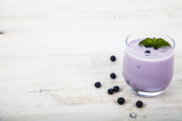 Blueberry yogurt on a wooden table .