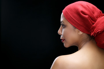Her own way of being beautiful. Studio shot of a profile of a gorgeous woman smiling warmly looking...