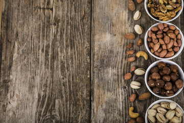 Nuts in a plate on a  wooden table.