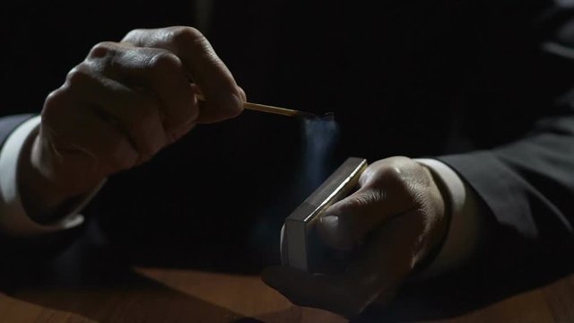 Male In Suit Blowing Out A Burning Match, Crisis And Depression, Slowmotion