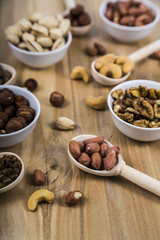Nuts in a wooden spoons and bowls