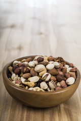Nuts in a wooden bowl  on a  wooden table.