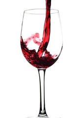 Pouring red wine into a glass against a white background