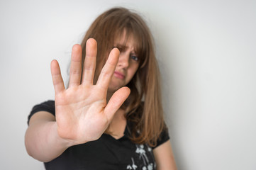 Woman is showing stop gesture with her hand