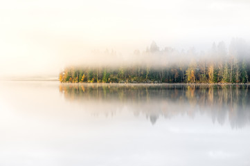 Scenic landscape with lake and fall colors at morning light