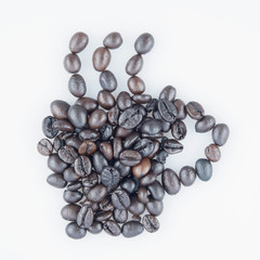 Black roasted coffee beans place as cup of coffee