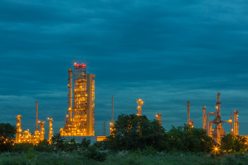 Obraz na płótnie Canvas Oil and gas refinery industry plant, Power electric factory, Chemical storage tanks at twilight.