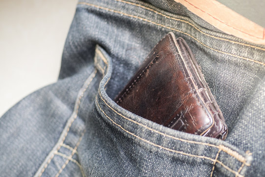Brown wallet in the pocket of old jean no wear