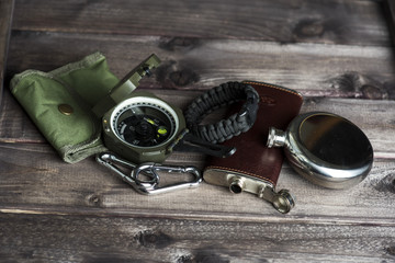 Travellers set for outdoor activity. Compass, watch, flask, carabiner