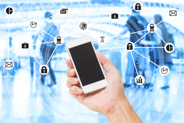 Hand holding mobile phone over double exposure of blurred people travel and data management system internet of things graphics design