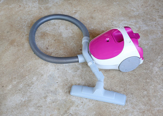 Vacuum cleaner on cement floor.