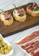 Tapas typical of the Spanish gastronomy. Ham, olives and beer. Food. Vertical shoot.