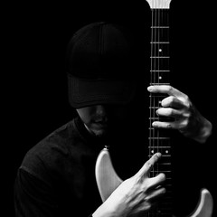 Obraz premium asian handsome musician posing on electric guitar. black and white