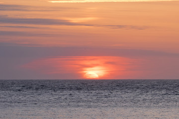 Background image of a sunset with a colorful sky at the sea (San Sebastian, Spain).