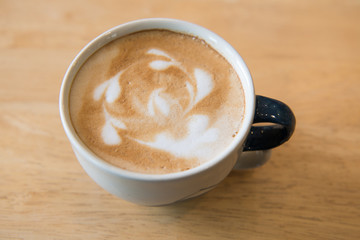 hot latte coffee on wood table