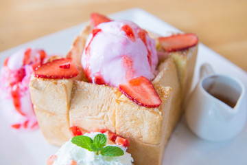 Honey toast with whipped cream,ice cream and strawberry