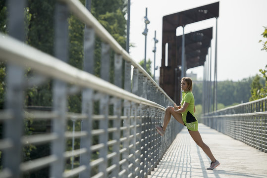 Female athlete stretching on bridge