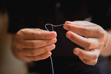 Woman's hand sewing fabric with sewing equipments