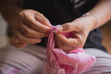 Woman's hand sewing fabric with sewing equipments
