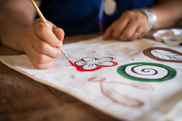 Girl use brush paint picture on bag