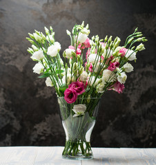 Glass vase with fresh flowers close-up