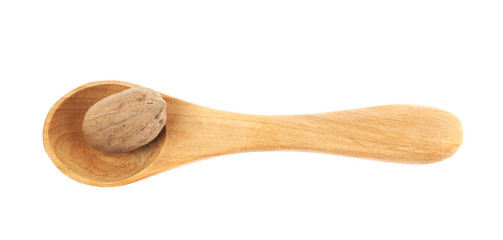 Wooden spoon and pecan nut composition