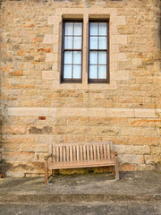 Fototapeta na wymiar wooden bench under window
