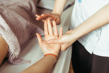 physical therapist massaging hands