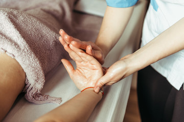 physical therapist massaging hands