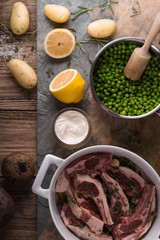 Ribs of lamb, potatoes, lemon, peas on slate