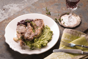 Serving of lamb ribs grill, mashed potatoes, beetroot sauce, lemon, wine, on the table side view