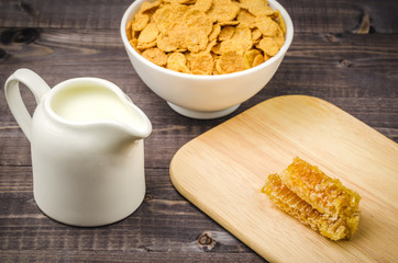 breakfast with honey and flakes on a wooden background/breakfast with honey and flakes on a wooden table