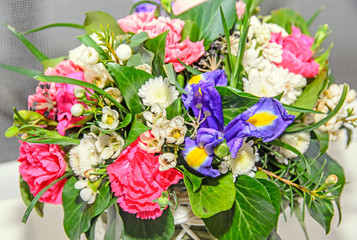 Floral arrangement with colored flowers roses, iris, chrysanthemums, Carnations, green leafs