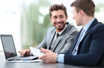 Fototapeta premium Two handsome businessmen working together on a project in the of