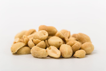 Fototapeta na wymiar Fried salted peanuts on white background. snack.