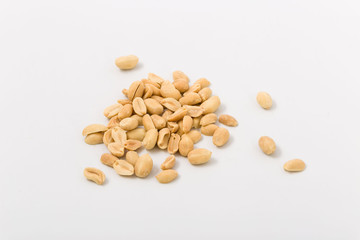 Fried salted peanuts on white background. snack.