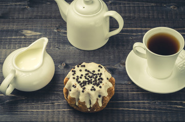 cup coffee, creamer, teapot, sweets on a wooden backgroundcup coffee, creamer, teapot,...