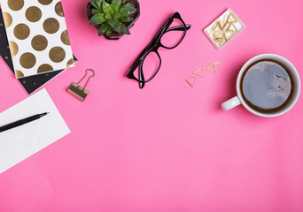 Feminine work accessories on pink background