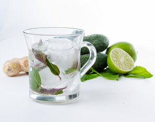 Fresh lemonade. Cucumbers lime ginger and green leaves