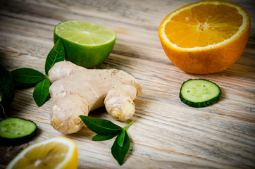  Cucumber ginger lemon lime and green mint leaves on a wooden background